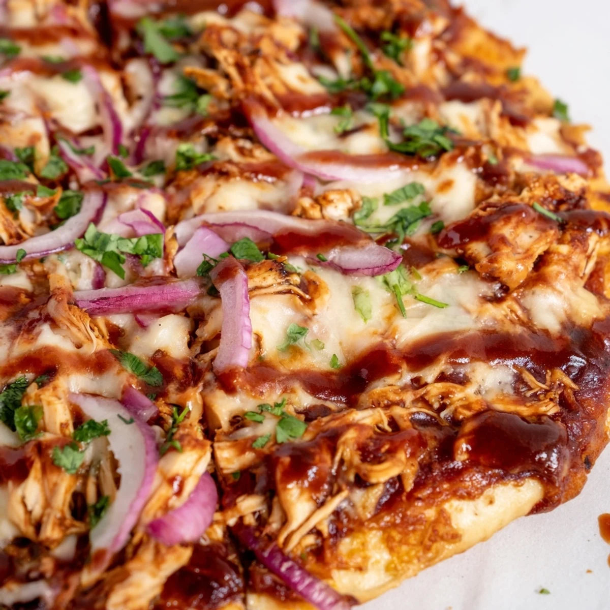 Golden-brown Game Day BBQ Chicken Pizza fresh from the oven, topped with juicy shredded chicken, tangy barbecue sauce, and melty mozzarella.  
