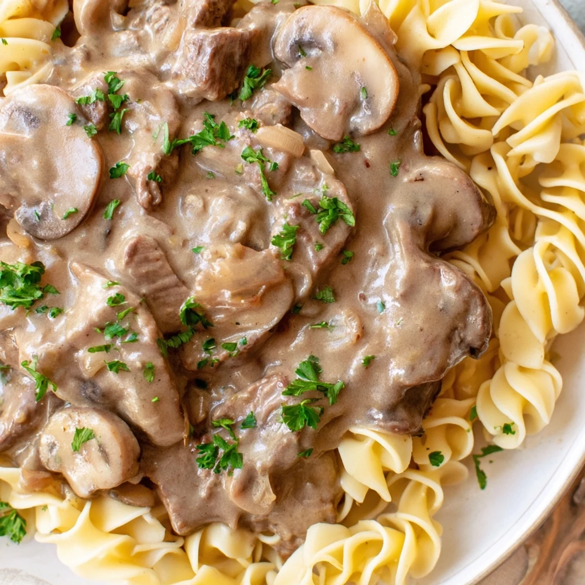 Tender strips of beef and sliced mushrooms in a rich, creamy gravy, served hot over a bed of egg noodles.