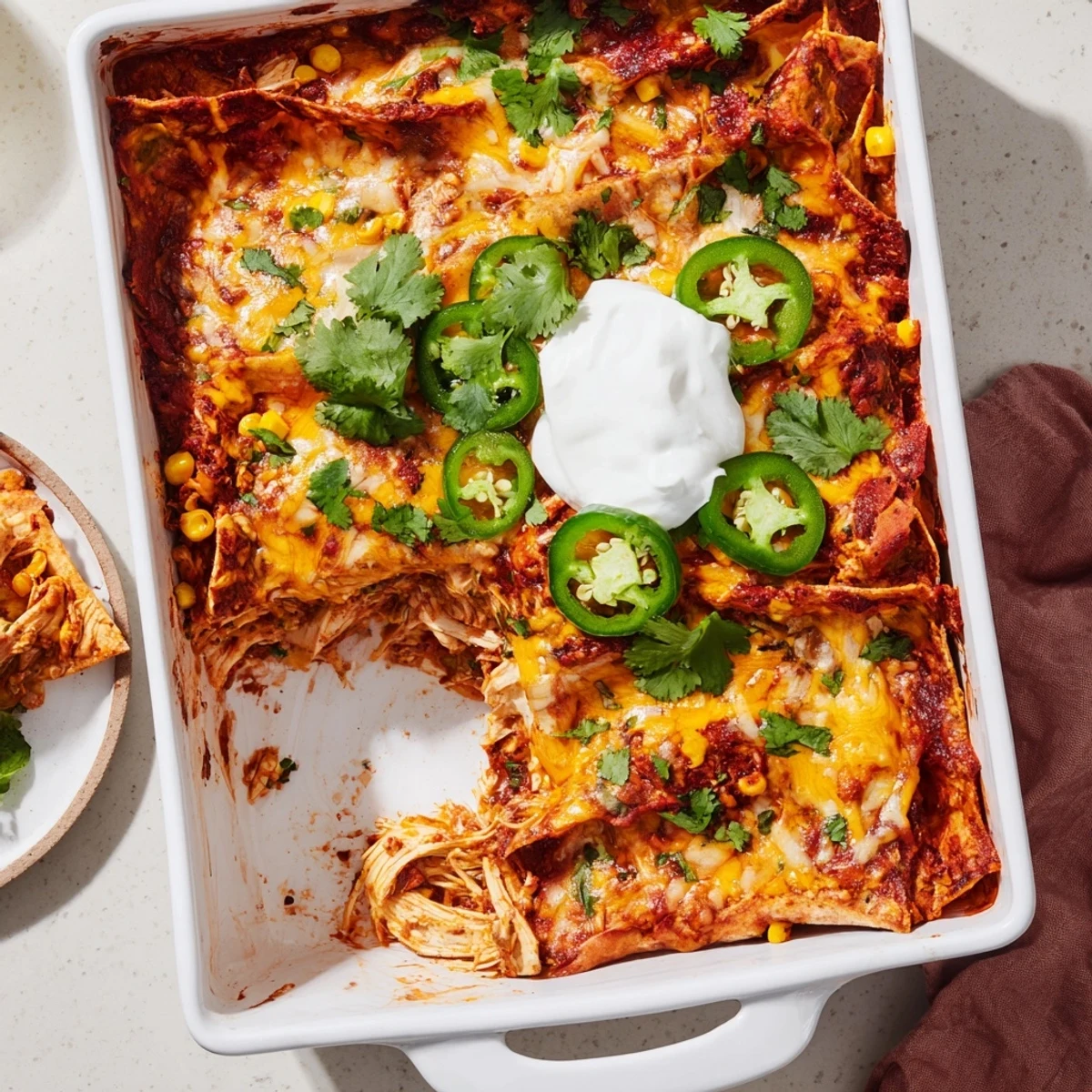 Golden-brown melted cheese blankets this bubbling Chicken Enchilada Casserole with Cheese, layered with soft corn tortillas and tender shredded chicken.