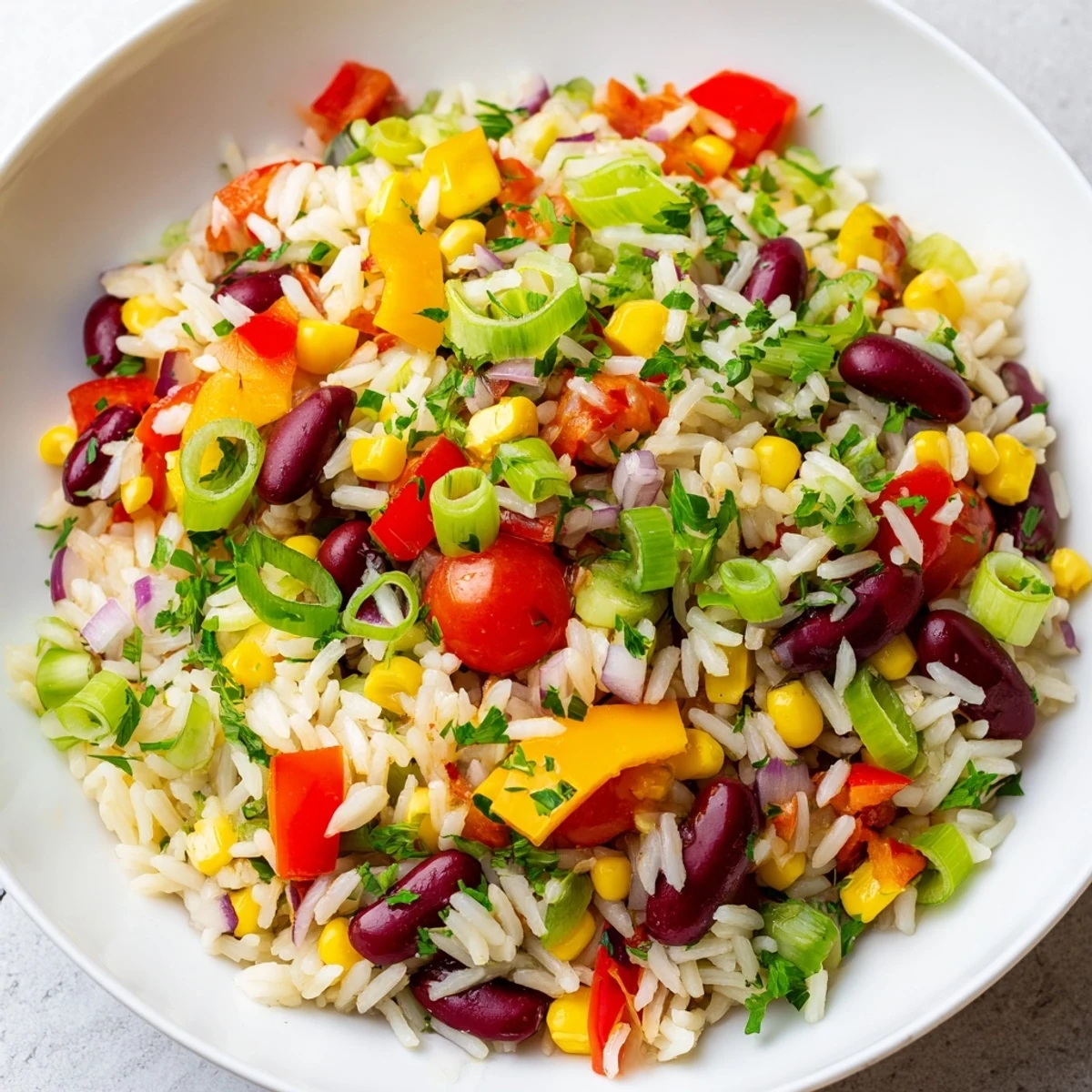 Hearty Mardi Gras Veggie Rice Bowl with Cajun-spiced vegetables and beans over rice.
