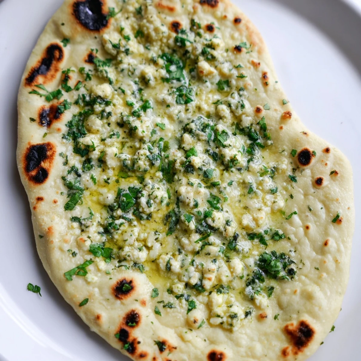 Warm, golden Cottage Cheese Garlic Naan fresh off the skillet, brushed with melted butter and garlic.