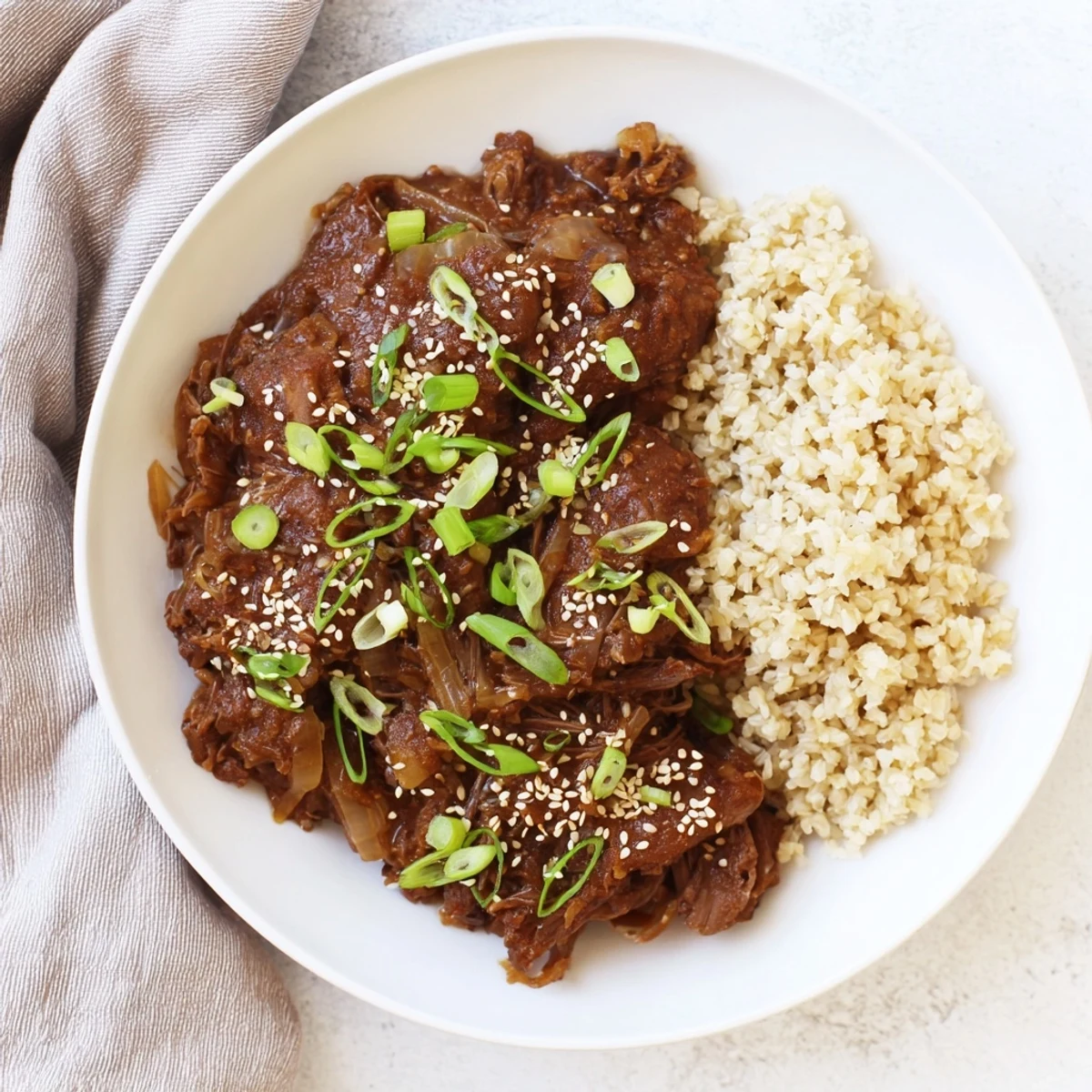 Close-up of Crock Pot Korean Beef in a slow cooker, showcasing juicy beef coated in a savory Korean-inspired sauce.