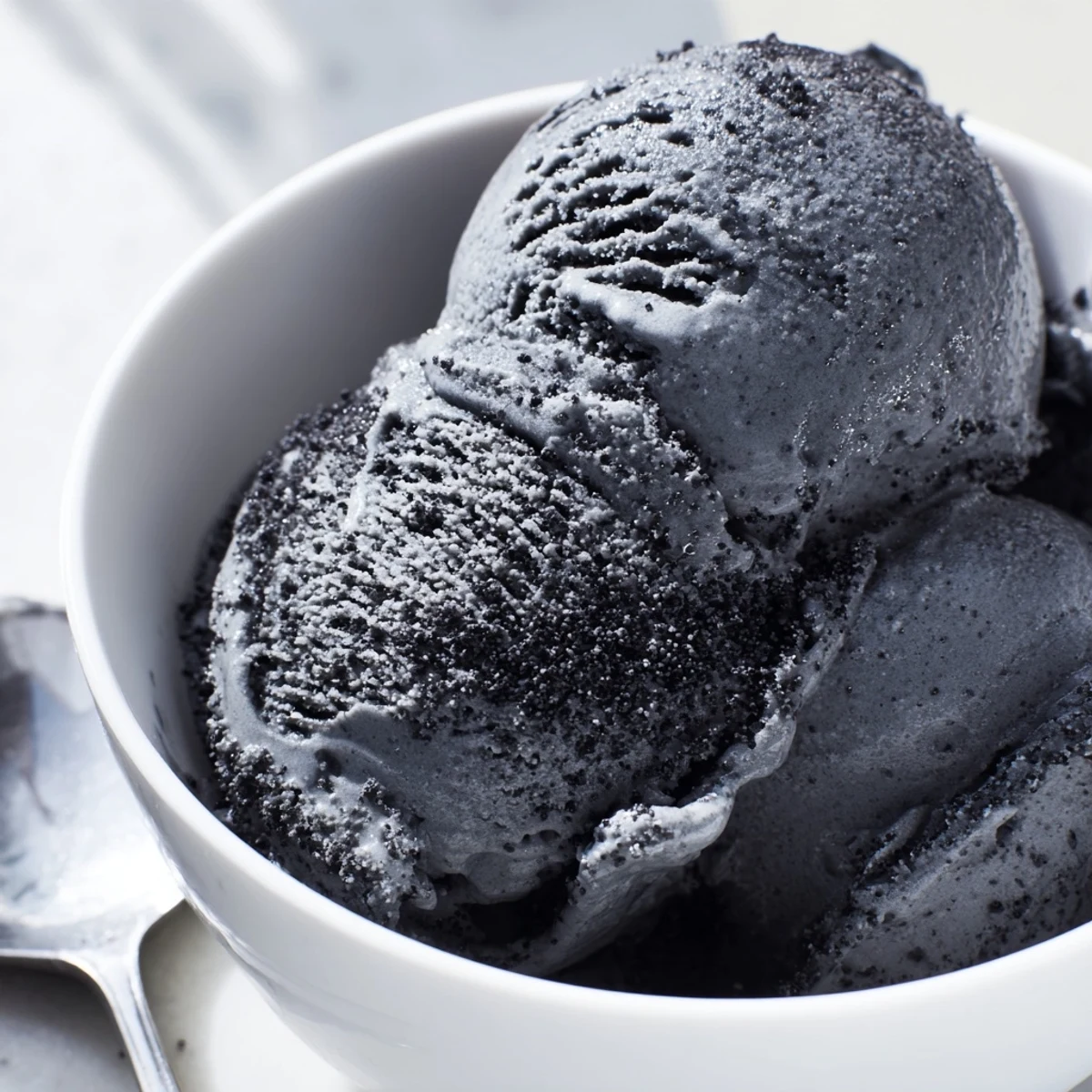 Homemade toasted black sesame ice cream recipe in a chilled dish, ready to serve cold.