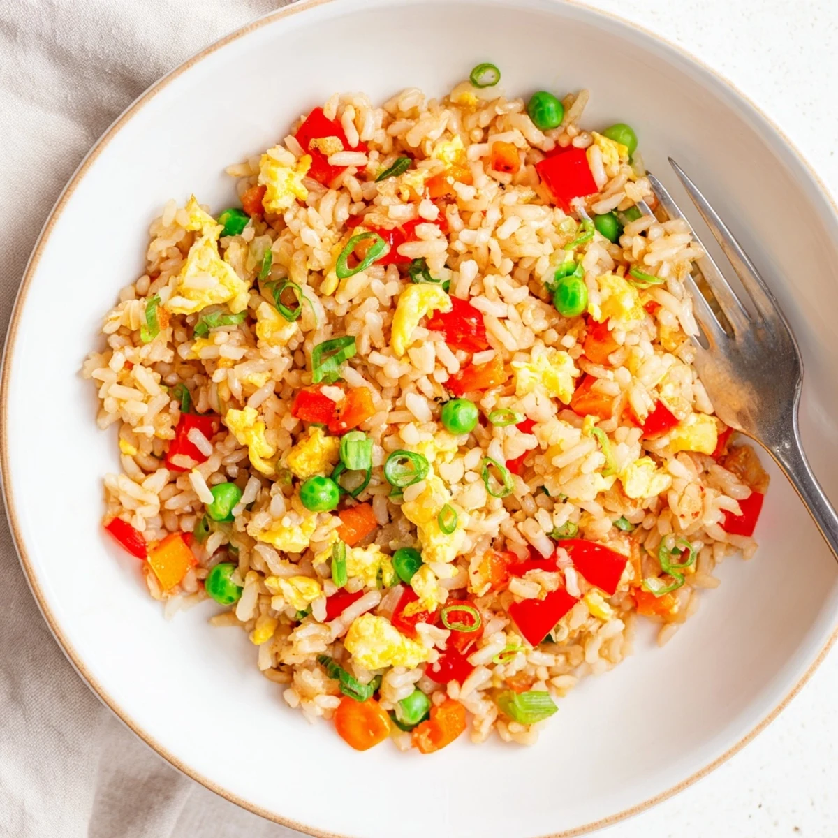 This Fried Rice features fluffy grains mixed with colorful vegetables and savory seasonings in a hot wok.  