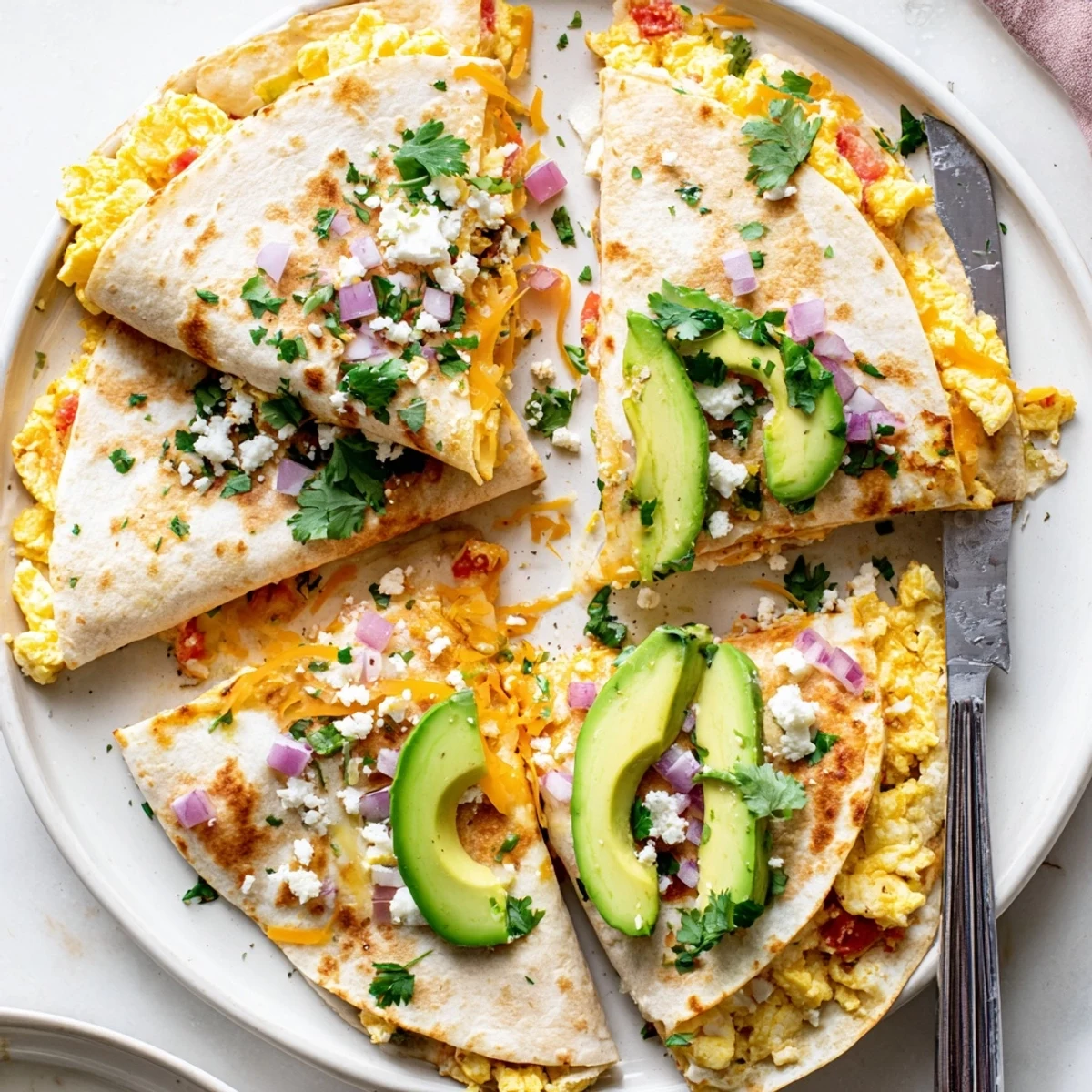 Golden-brown Spicy Avocado Egg and Three Cheese Quesadillas are sliced on a wooden board, revealing melted cheddar, Monterey Jack, and feta.