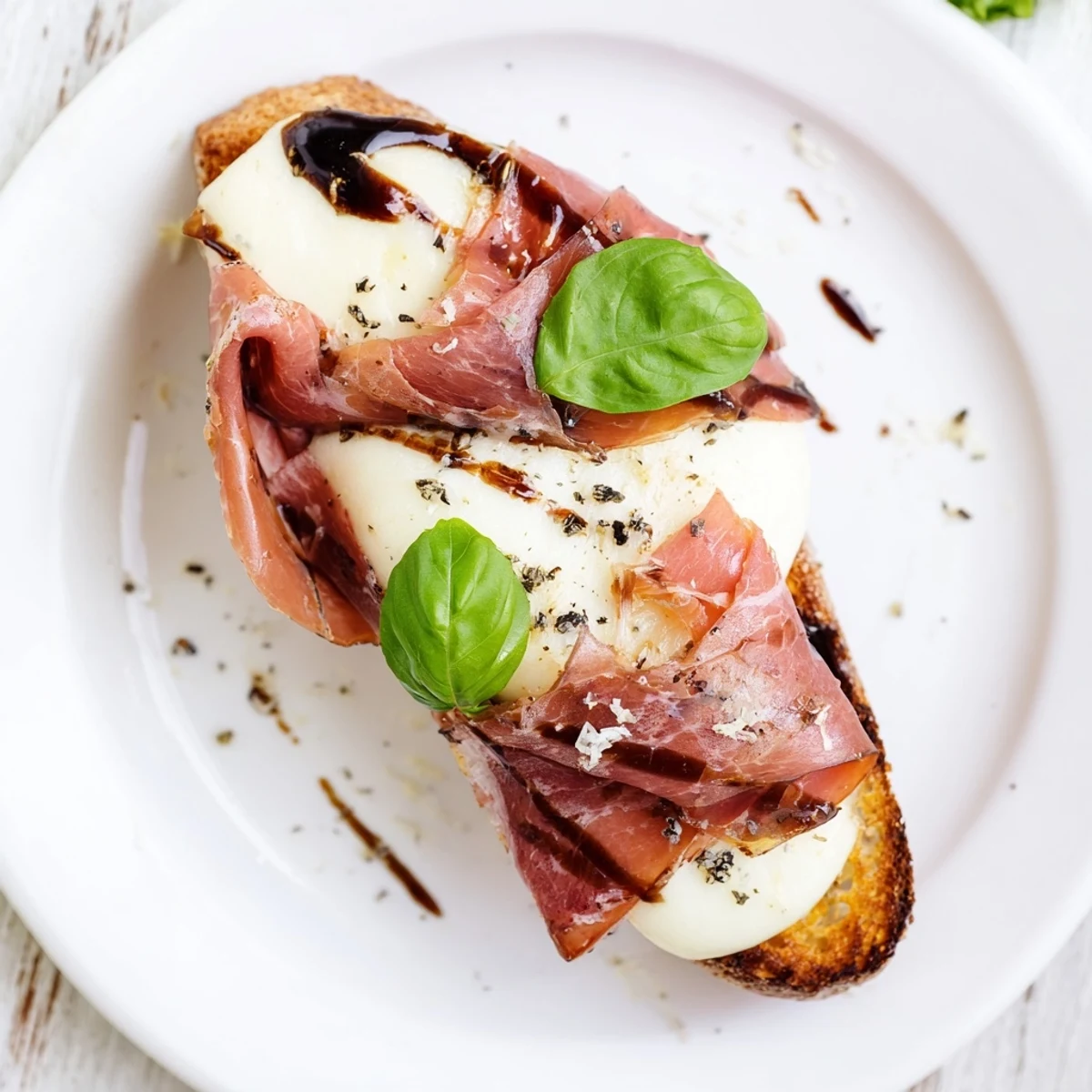 Golden toasted bread rounds holding warm mozzarella, delicate prosciutto, and savory roast beef, perfect for a party appetizer platter.