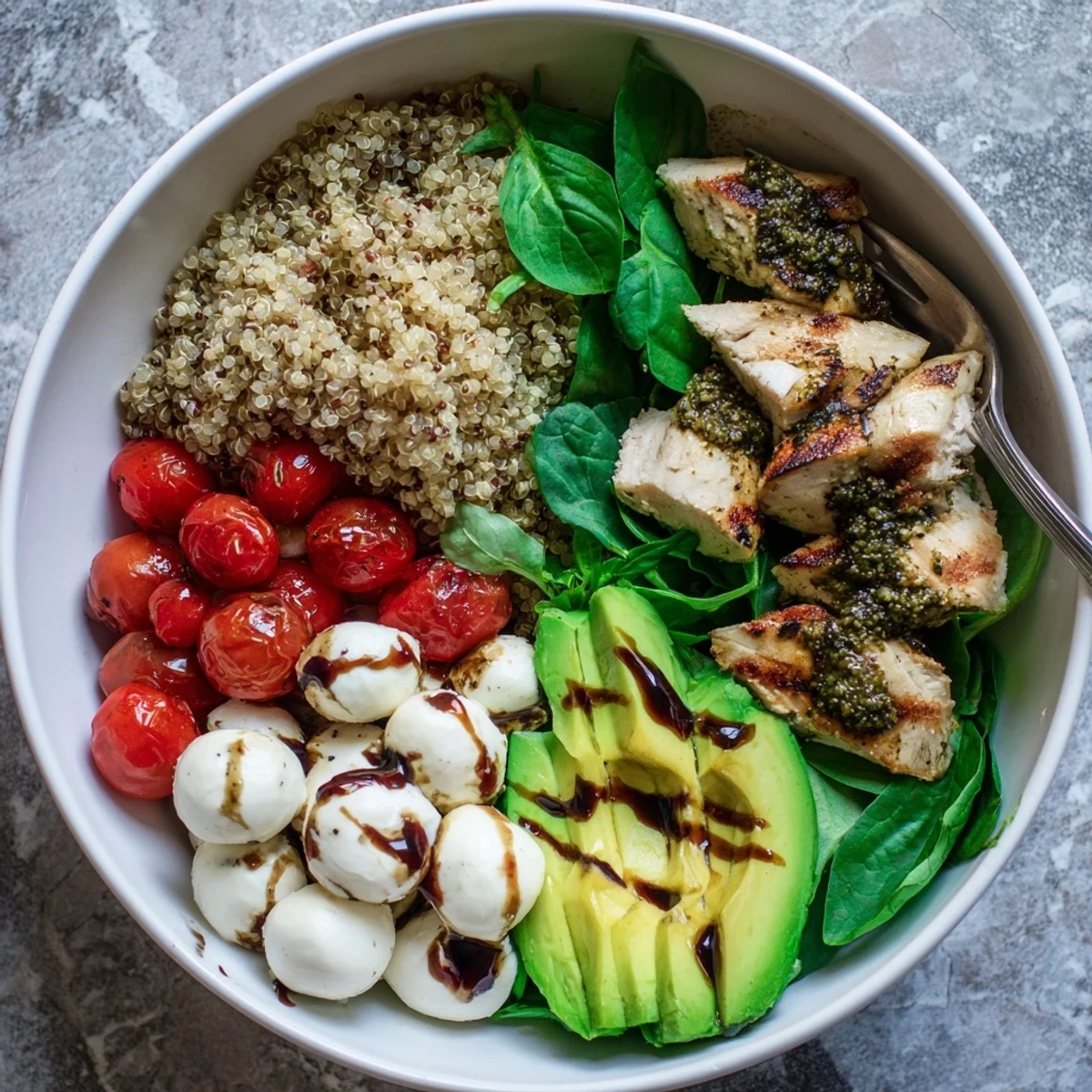 Vibrant Pesto Chicken Caprese Grain Bowl with juicy sliced chicken and fresh mozzarella.