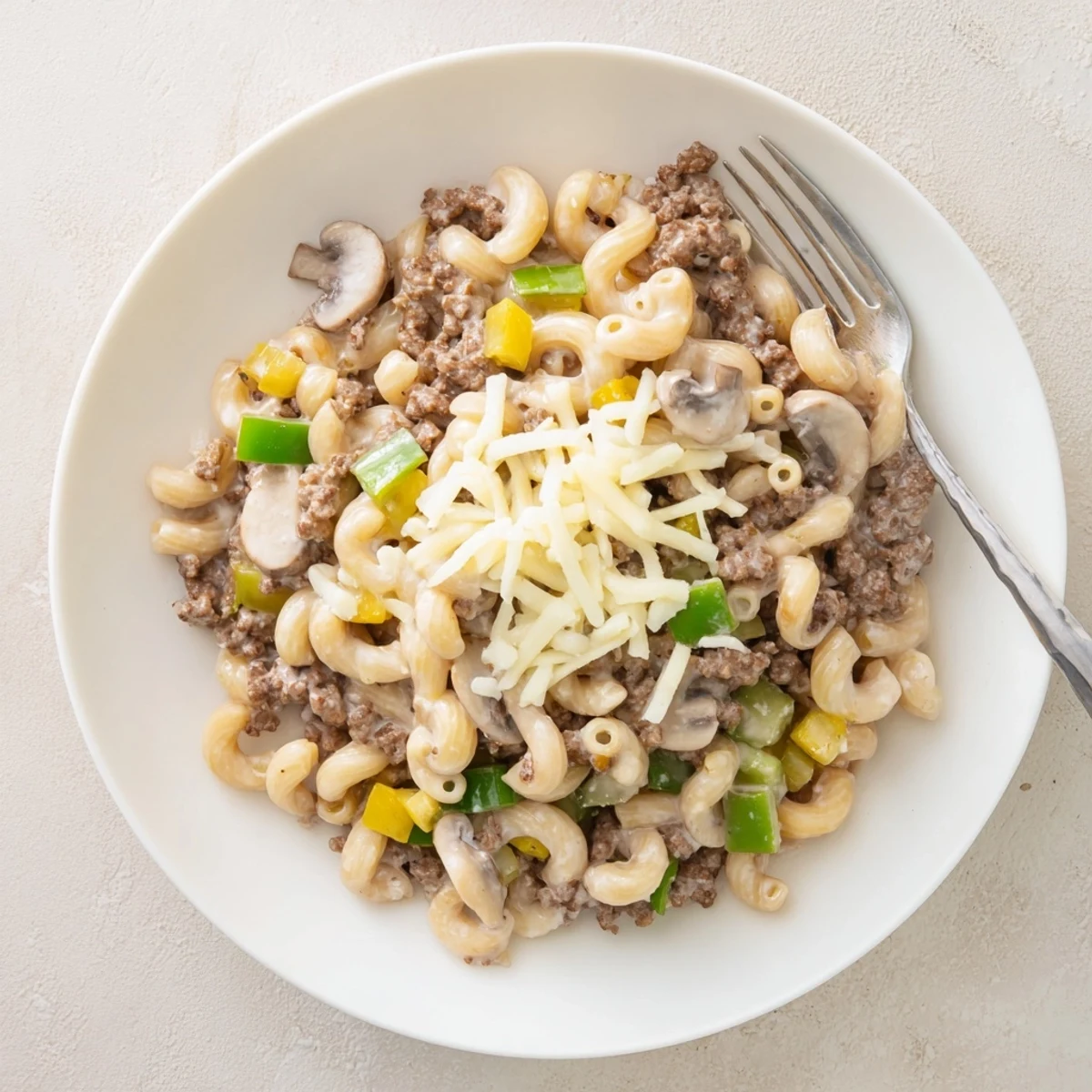 A close look at Easy High Protein Philly Cheesesteak Mac, featuring ground beef and creamy sauce, perfect for dinner.