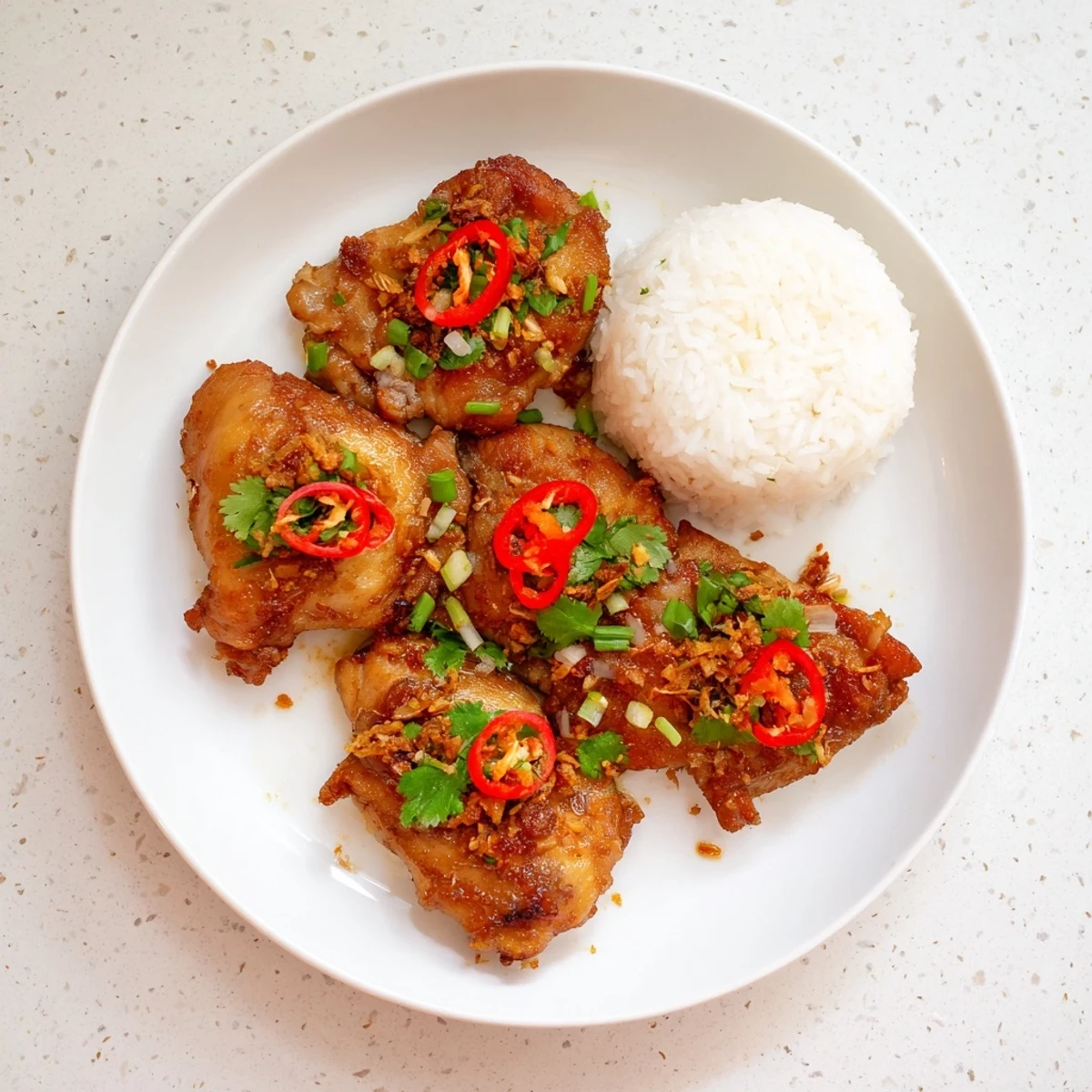 Succulent Vietnamese Lemongrass Chicken served alongside steaming vermicelli noodles and fresh herbs, capturing the aromatic and savory essence of the dish.
