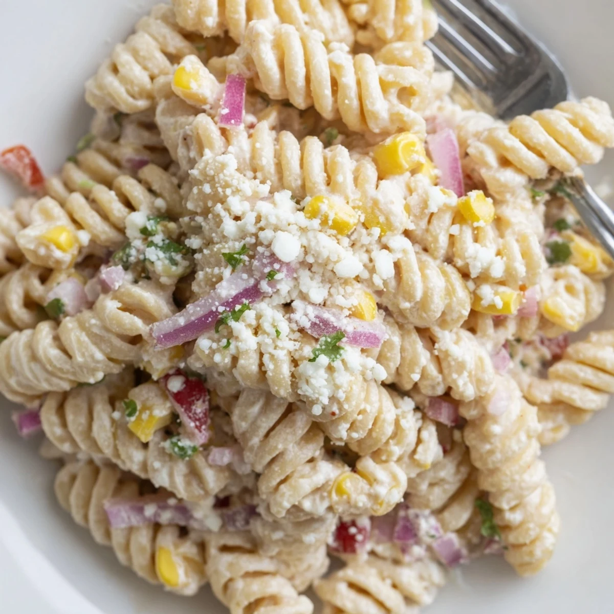 Creamy Mexican street corn pasta salad tossed with zesty lime dressing and crumbled white cheese
