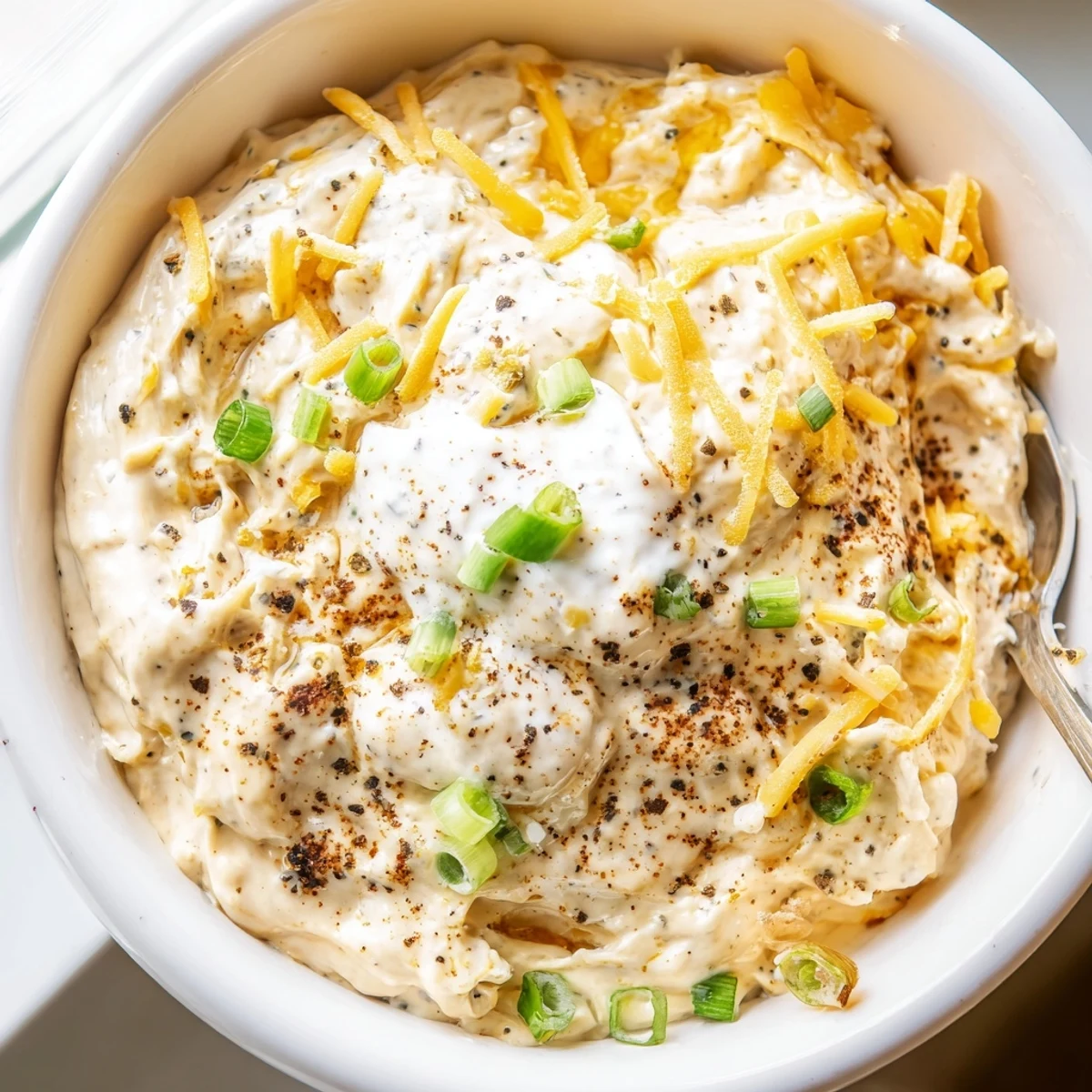 Tangy Dijon savory pretzel dip garnished with green onions for party appetizer