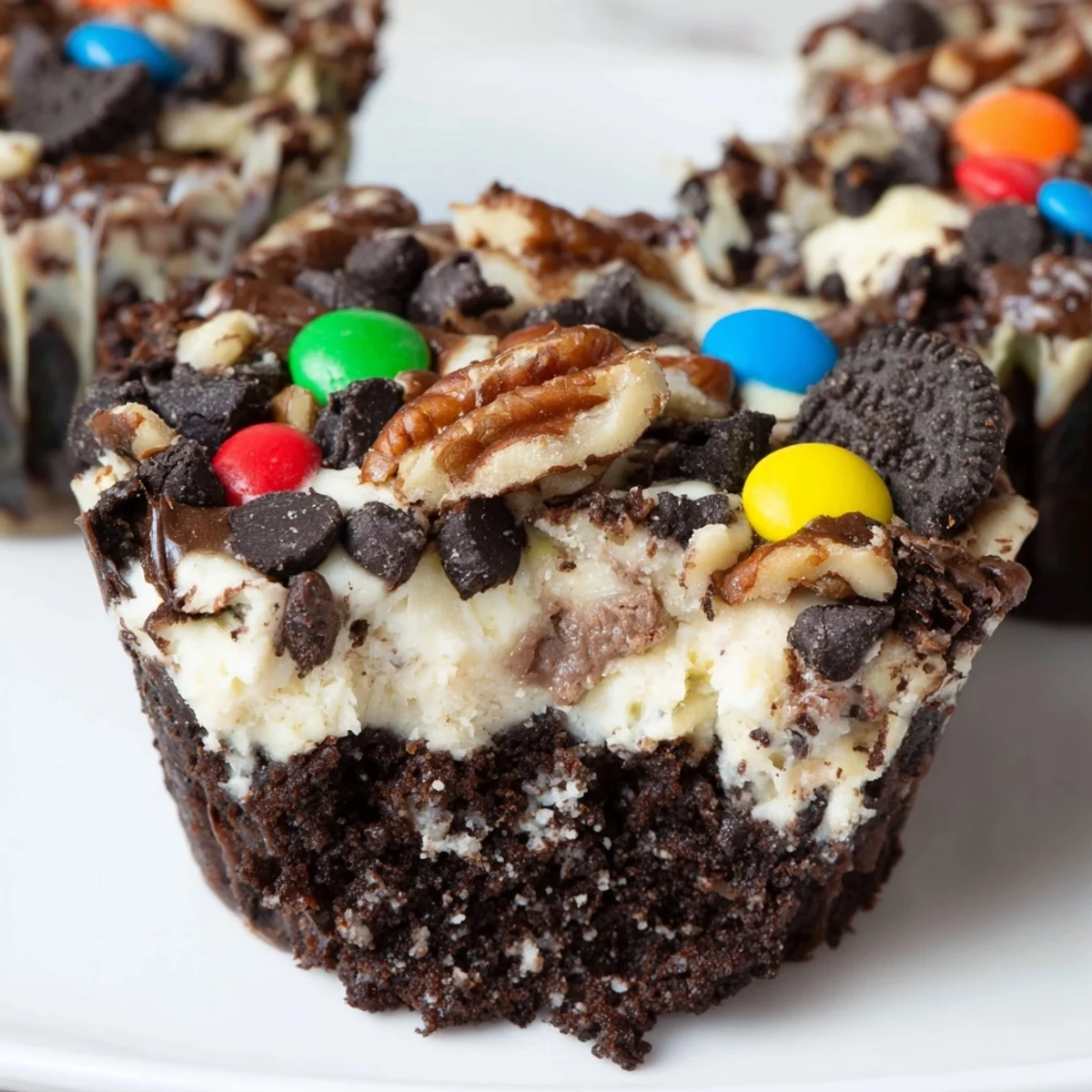 Decadent loaded brownie cheesecake cups with creamy cheesecake filling and crunchy nut toppings