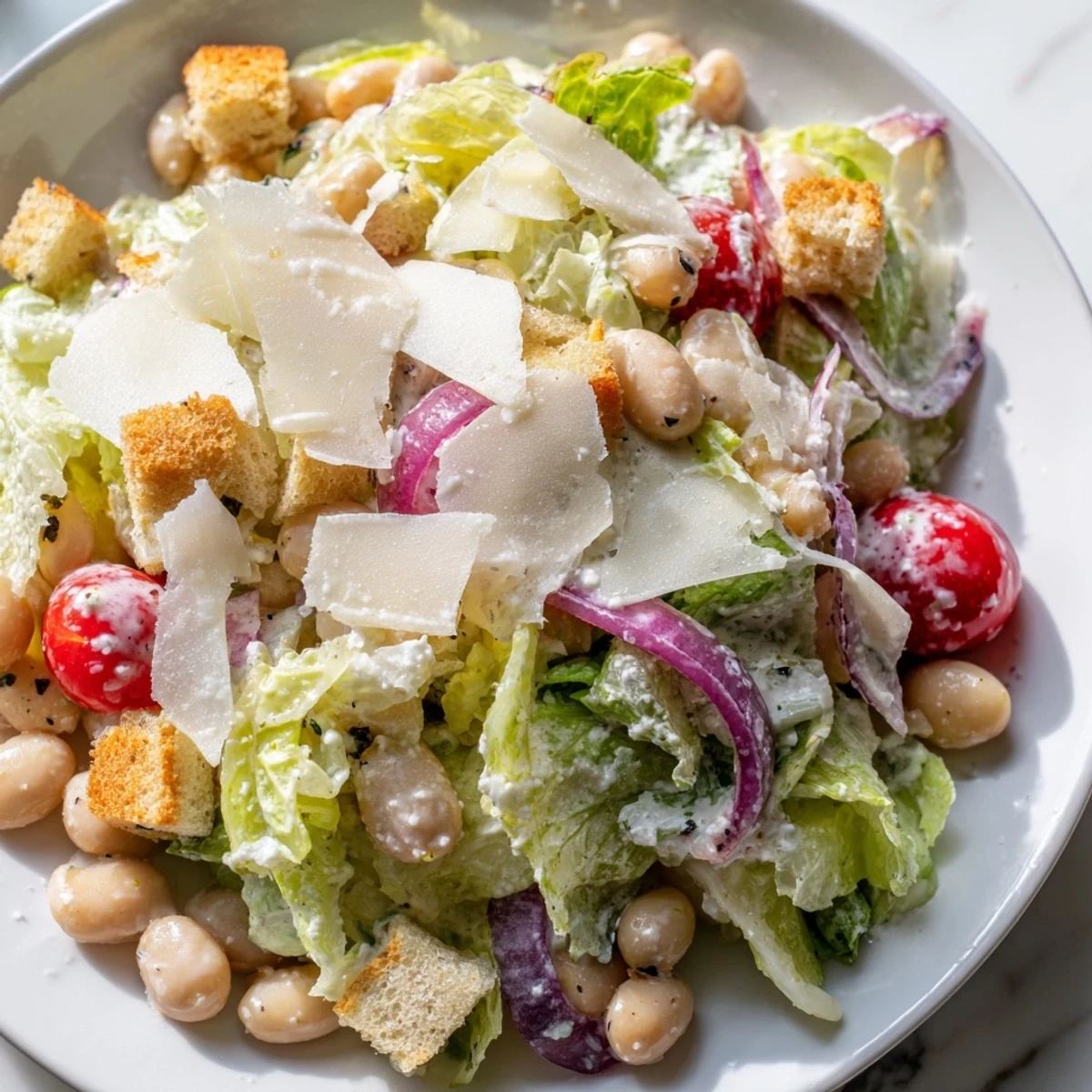 Fresh butter bean Caesar salad tossed in tangy homemade dressing with crunchy croutons
