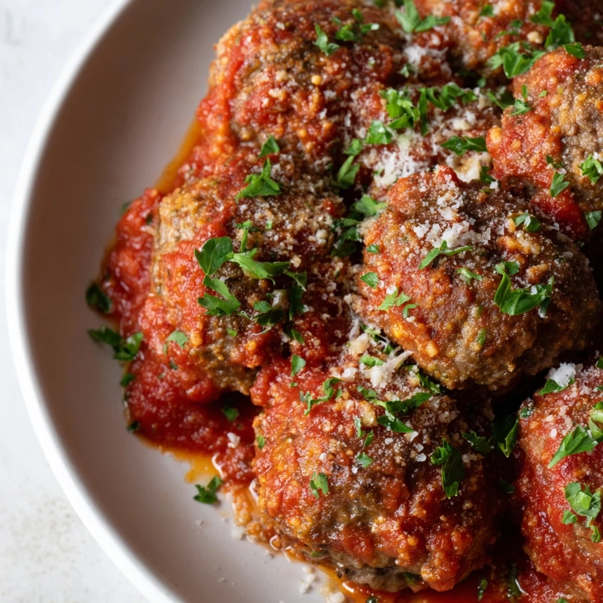 Tender beef and pork Italian meatballs coated in thick savory tomato sauce over pasta