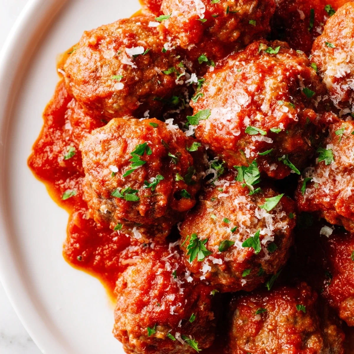 Homemade authentic Italian meatballs bubbling in herb tomato sauce ready for family dinner