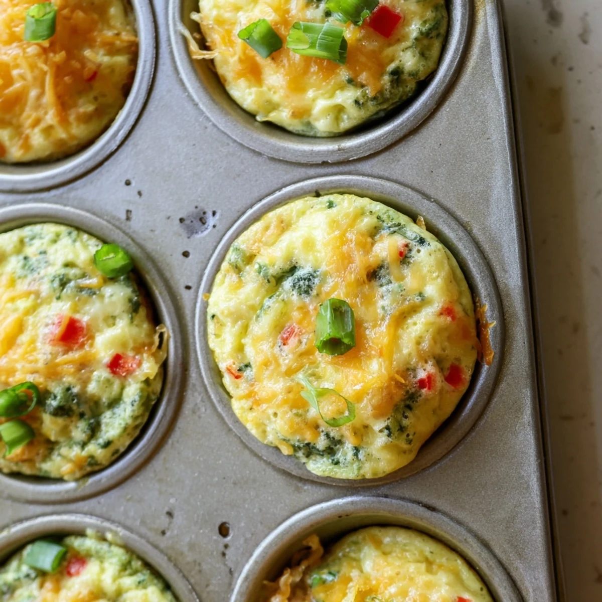 Golden baked cottage cheese egg bites with colorful spinach and bell pepper pieces
