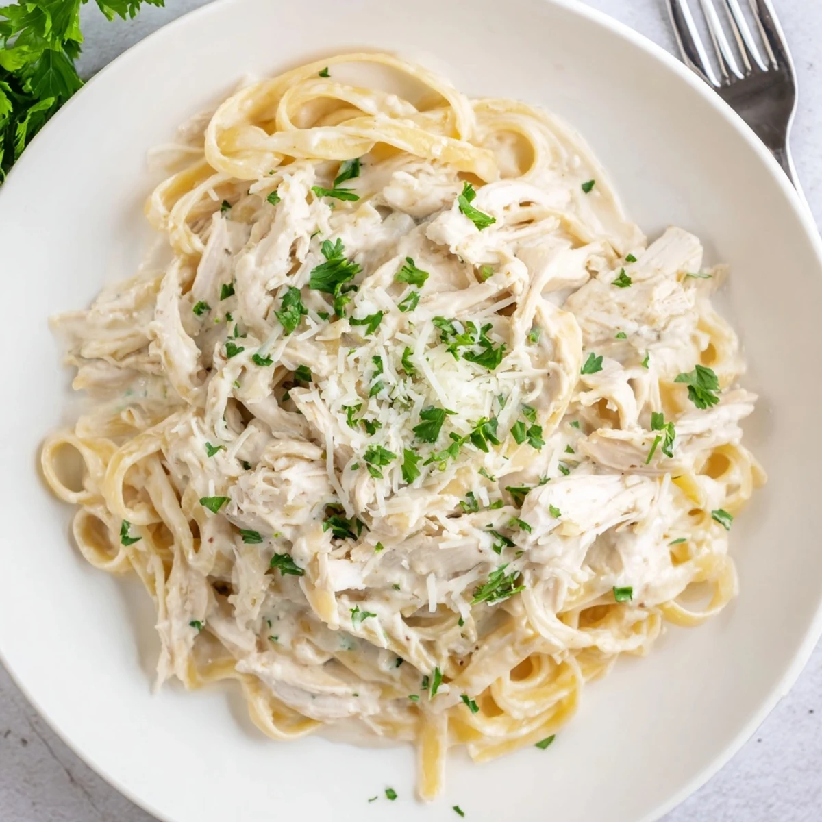 Hearty Chicken Alfredo pasta dish featuring juicy chicken in velvety garlic cream sauce