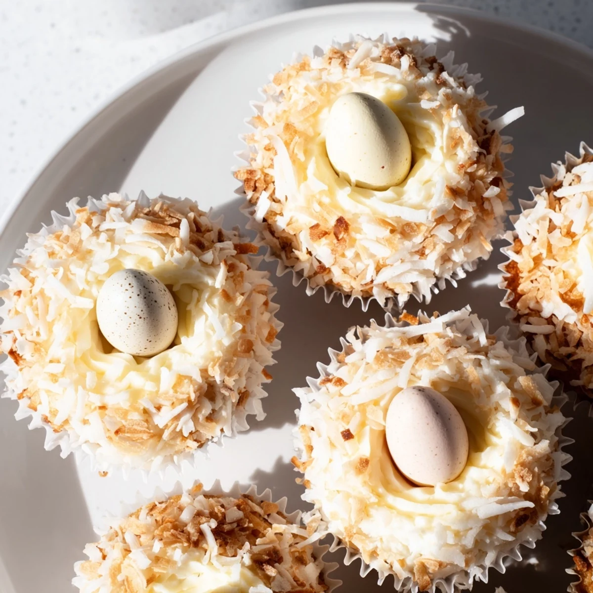 Moist coconut nest cupcakes featuring golden toasted coconut nests filled with Cadbury mini chocolate eggs