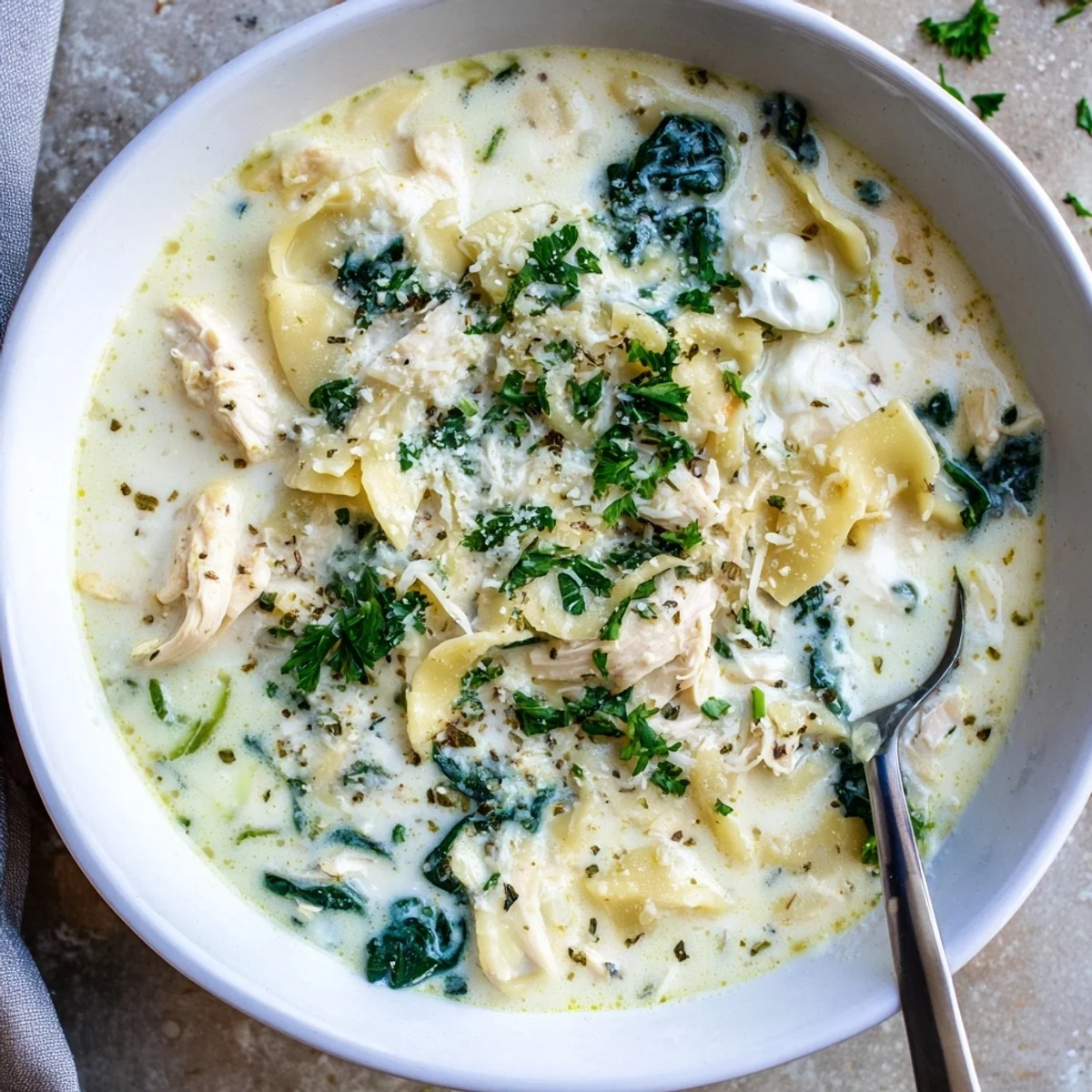 Hearty bowl of white lasagna soup topped with melted mozzarella and fresh parsley