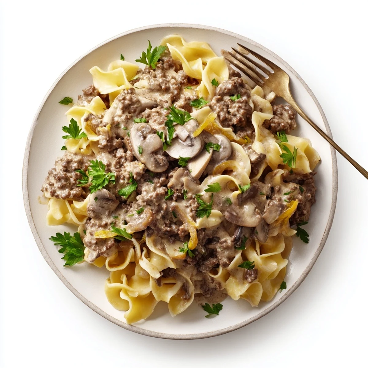 Creamy hamburger stroganoff with tender beef, mushrooms, and egg noodles garnished with fresh parsley