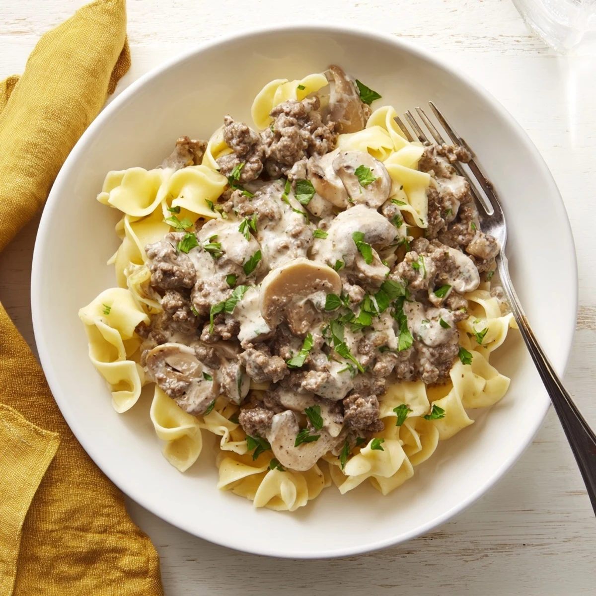 Rich hamburger stroganoff served over wide egg noodles with savory ground beef and mushroom sauce