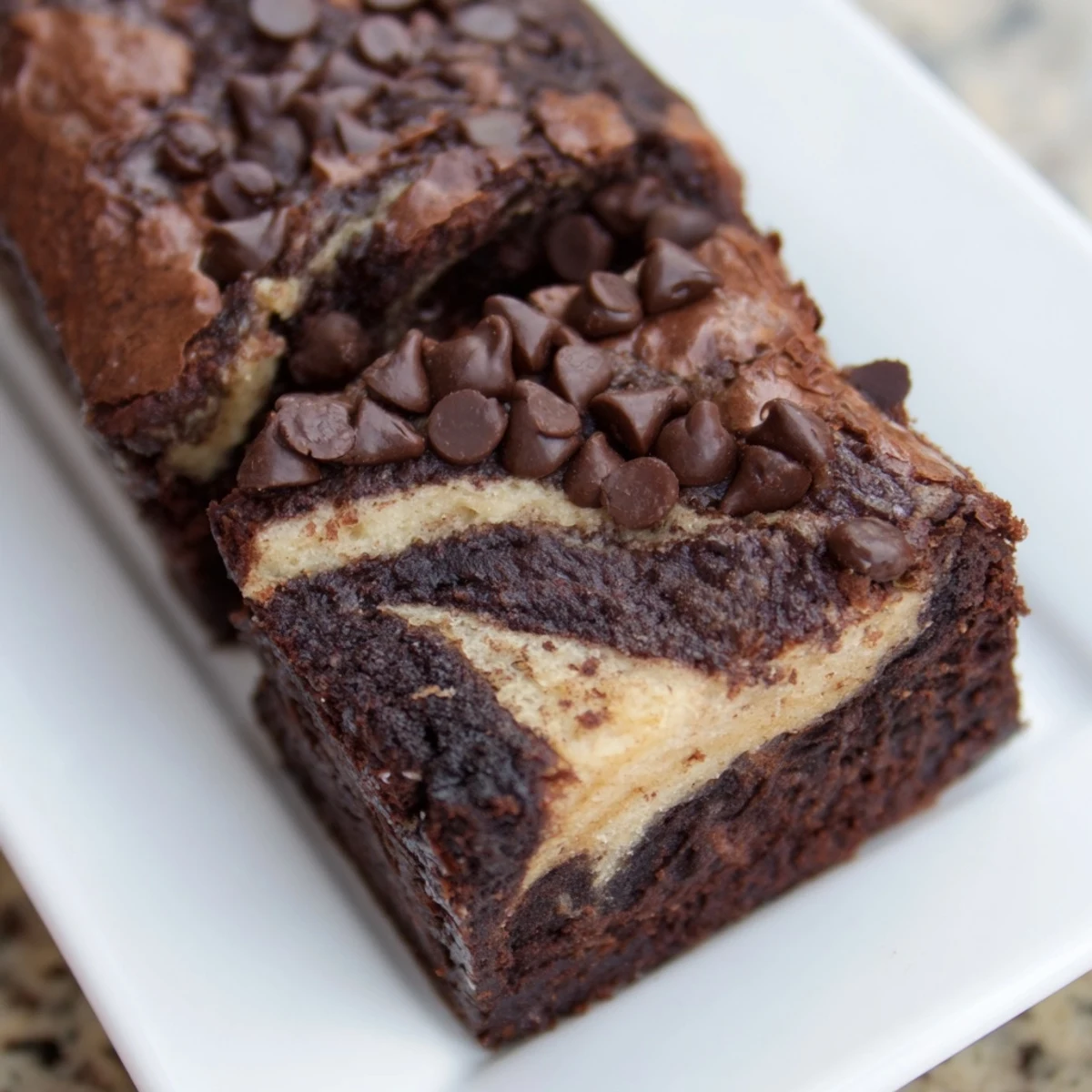 Sliced banana bread brownie bars showing moist texture with chocolate chip bits throughout