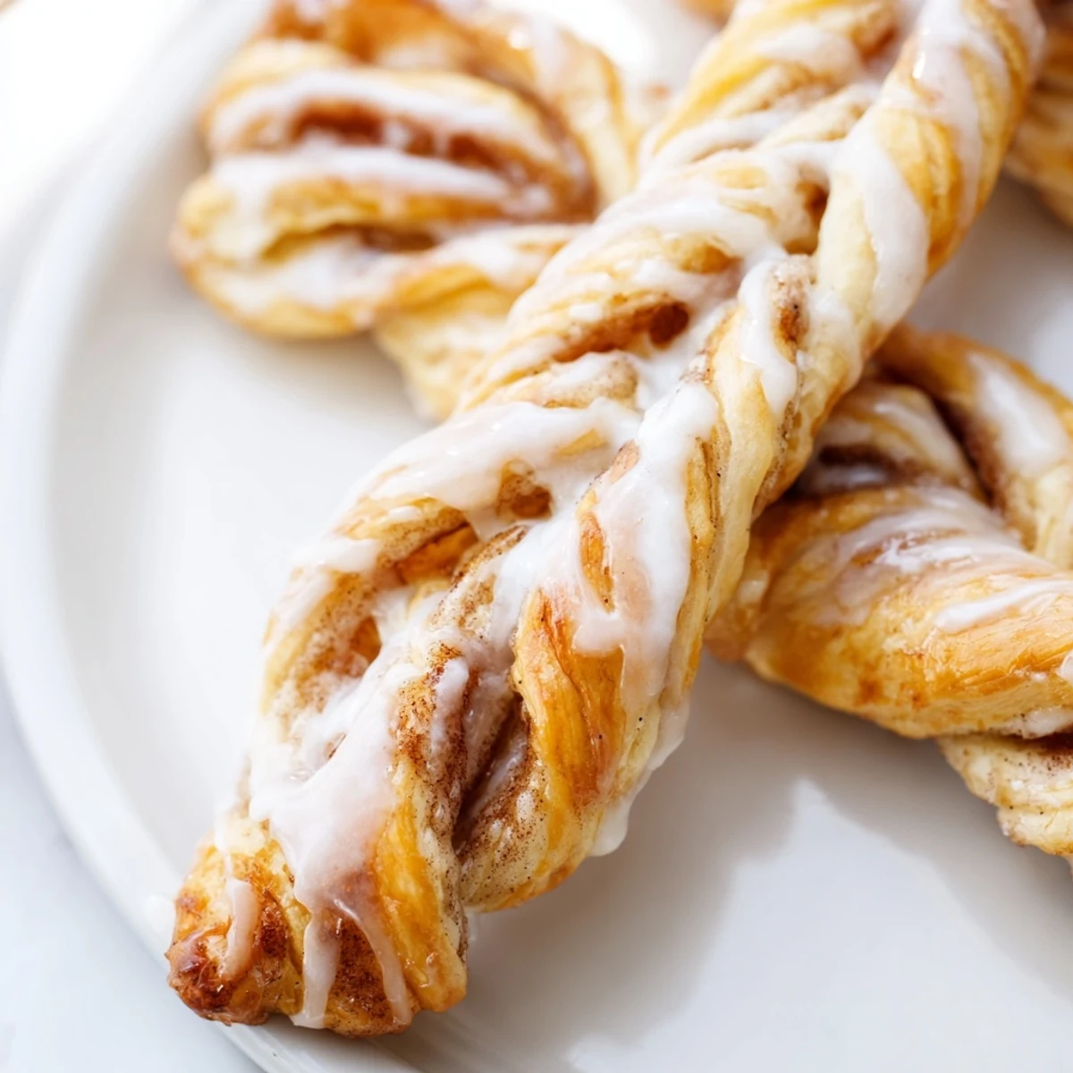 Soft baked sweet cinnamon twists with swirling cinnamon sugar filling and white glaze