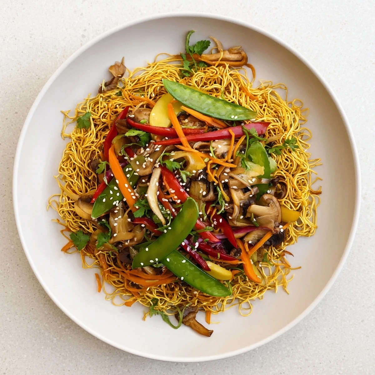 Golden crispy noodles topped with colorful stir-fried vegetables in savory sauce