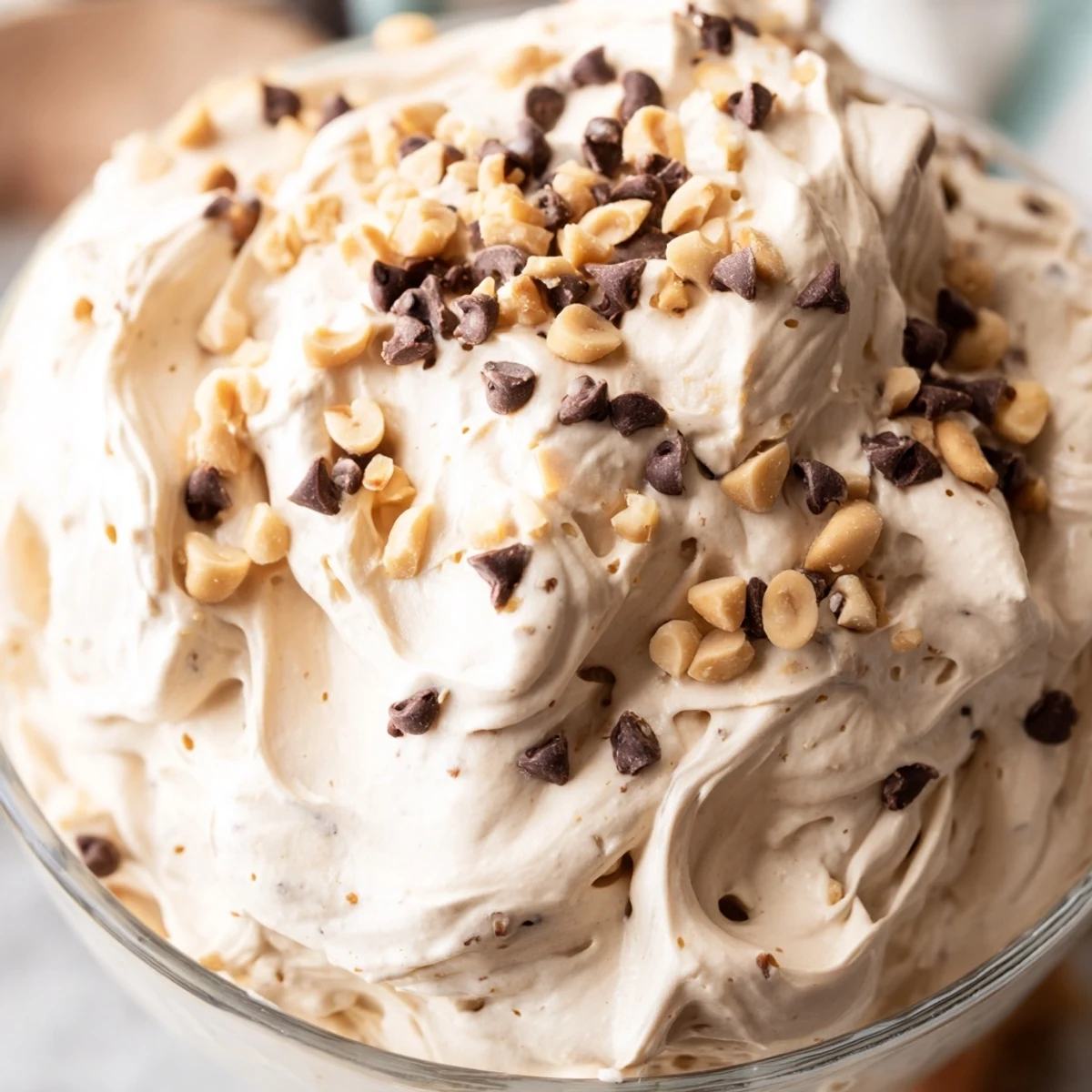 Fluffy peanut butter mousse dessert with whipped texture and chopped roasted peanut garnish
