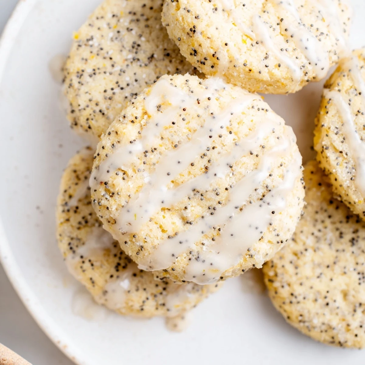 Chewy lemon poppy seed cookies drizzled with sweet tangy glaze on a cooling rack
