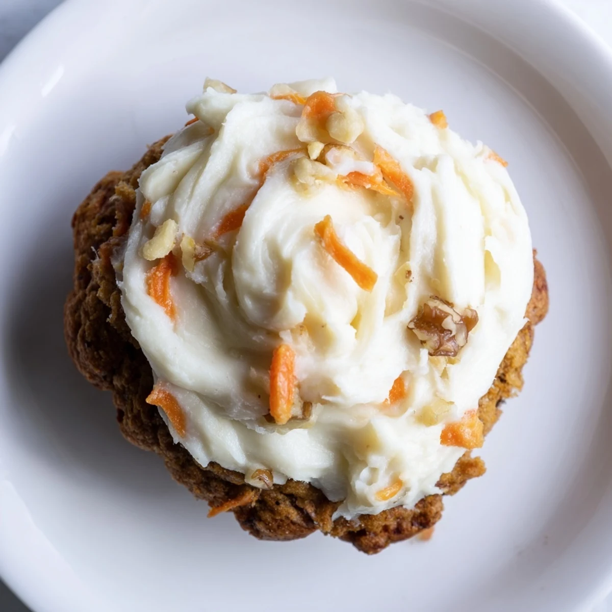 Soft baked Crumbl carrot cake cookies piled high with fluffy cream cheese frosting