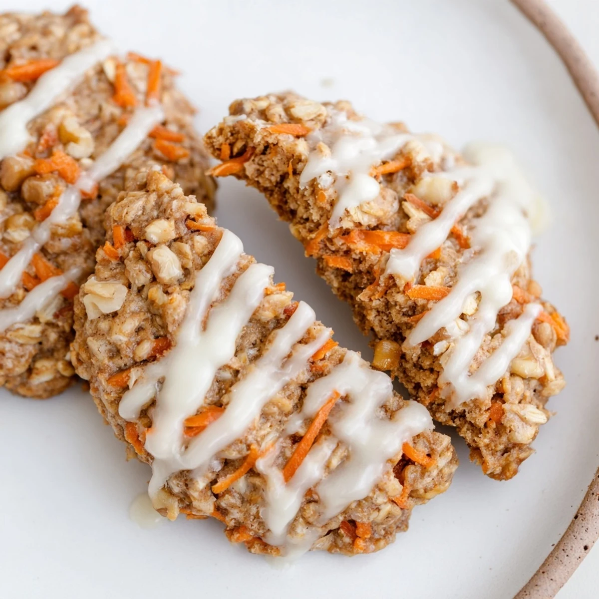 Golden Chewy Brown Butter Carrot Cake Cookies with visible carrot shreds and chopped walnuts on rustic parchment paper