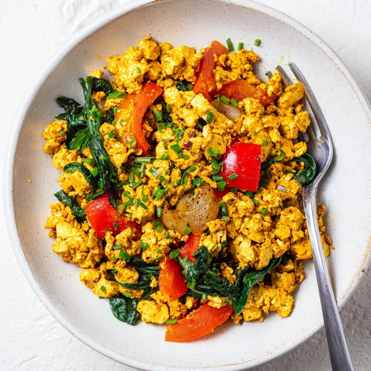 Creamy Tofu Scramble served hot with avocado toast and chopped chives