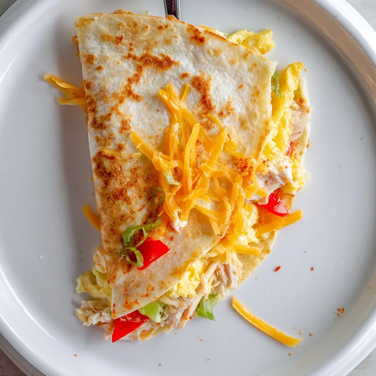 Hearty Chicken Breakfast Quesadilla sliced into wedges, warm chicken and veggies