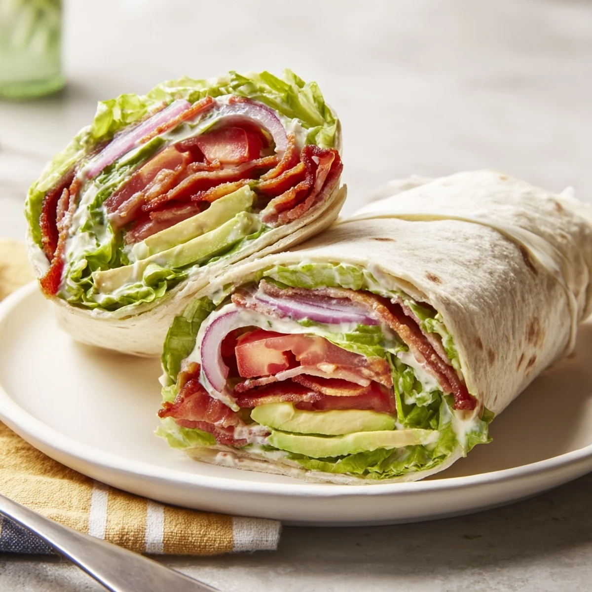 Meal Prep BLT Wraps with crispy bacon, crisp lettuce, juicy tomatoes.