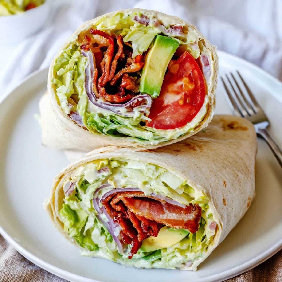 Stack of Meal Prep BLT Wraps, sliced, ready for quick weekday lunches.