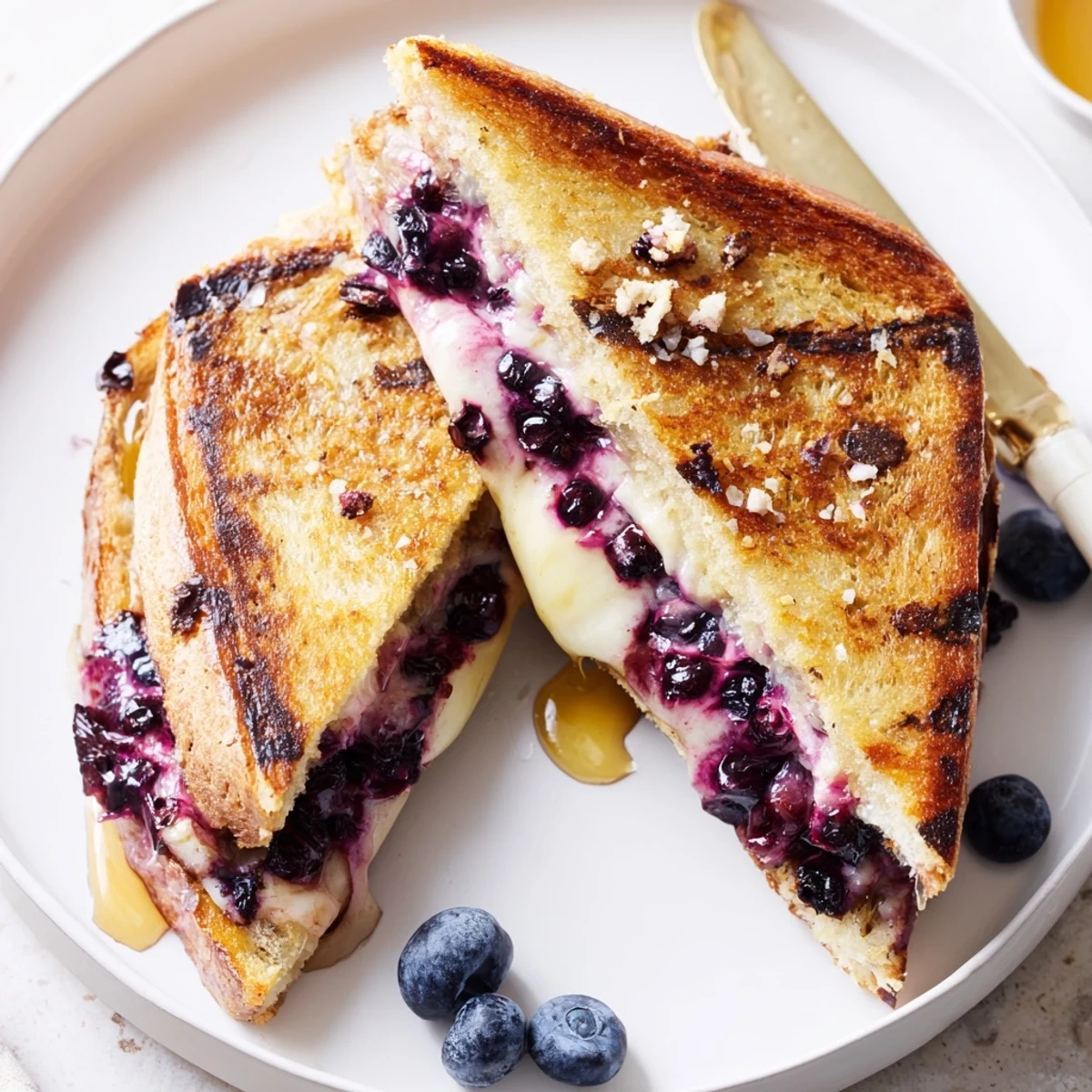 Juicy Blueberry Grilled Cheese with melted mozzarella, golden crust, warm berries  
