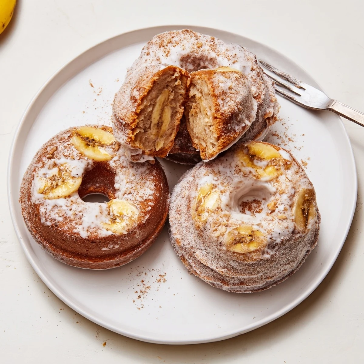Fresh Banana Donuts next to steaming coffee, soft crumb and cinnamon