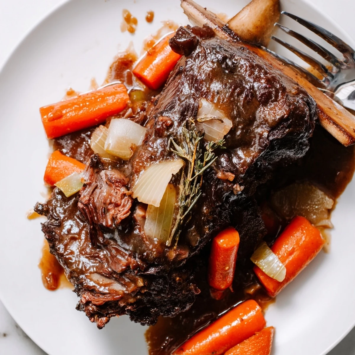 Slow Cooker Beef Short Ribs served hot with carrots, onions, and crusty bread