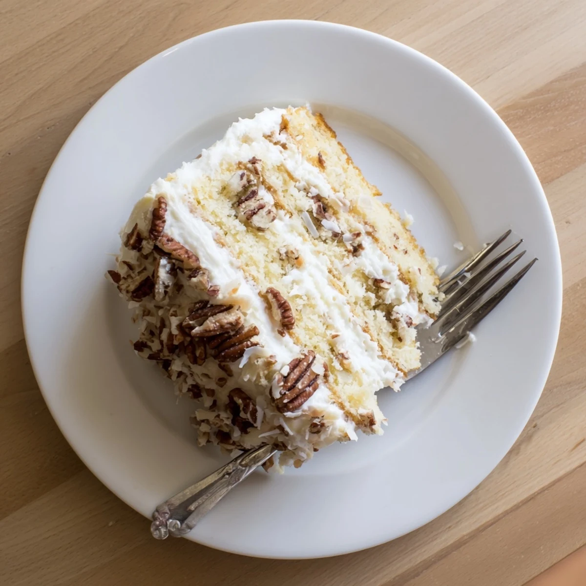 Moist Quick Italian Cream Cake layered with coconut pecans and creamy white frosting generously spread across the top