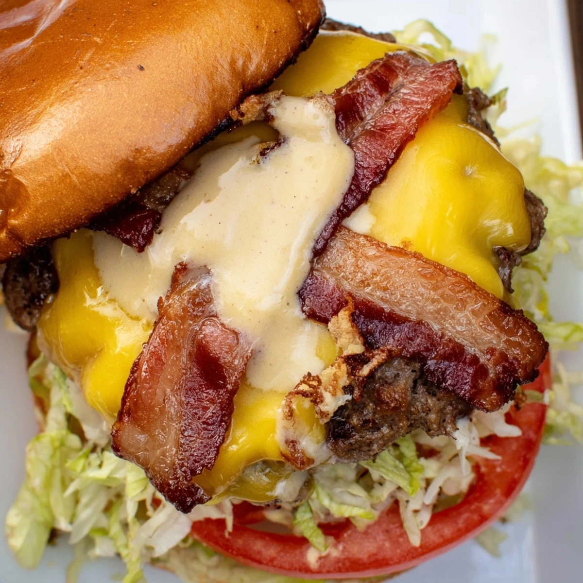 Juicy crack burgers topped with melted cheddar cheese and crispy bacon on toasted brioche buns