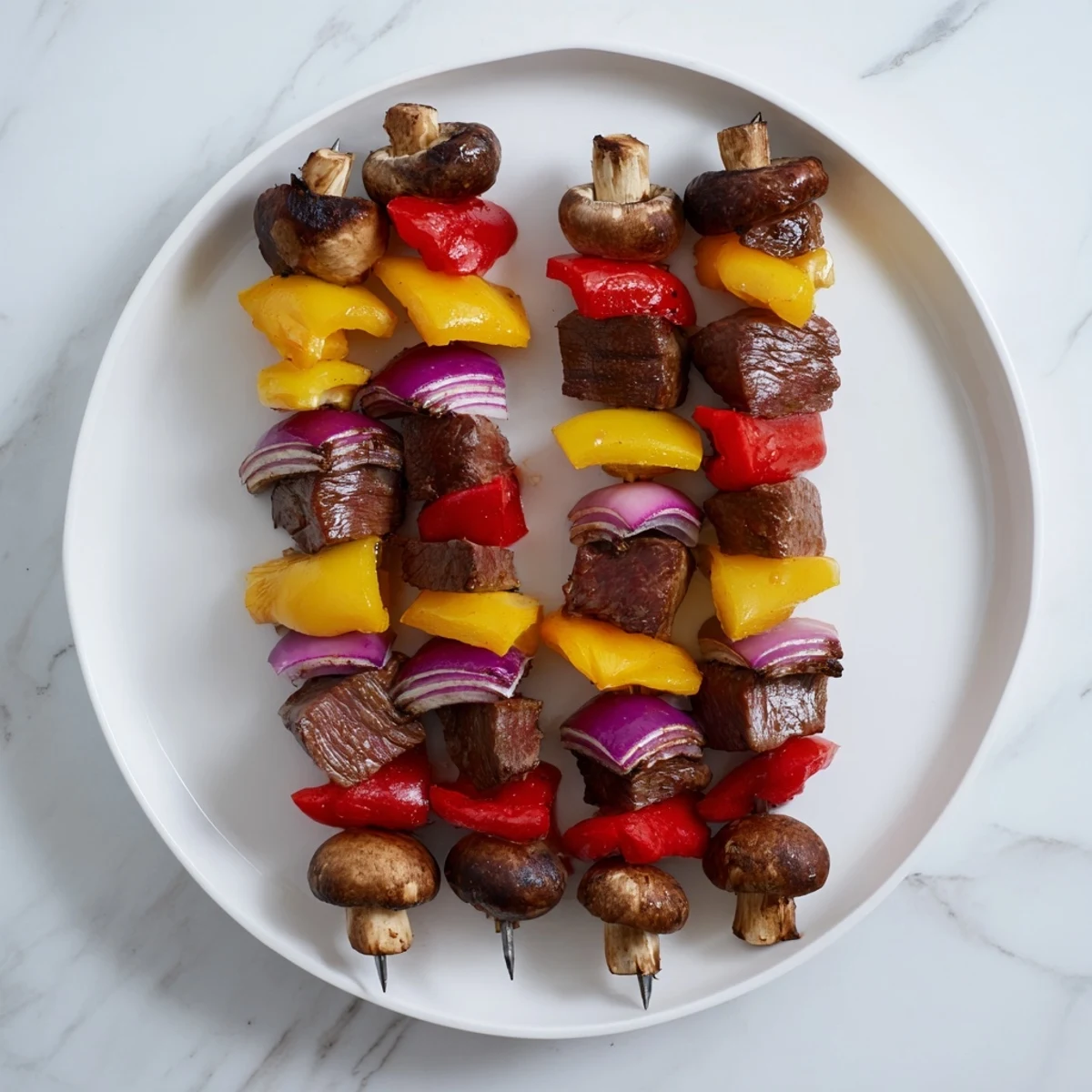 Tender juicy steak kebabs marinated in savory sauce with vibrant bell peppers