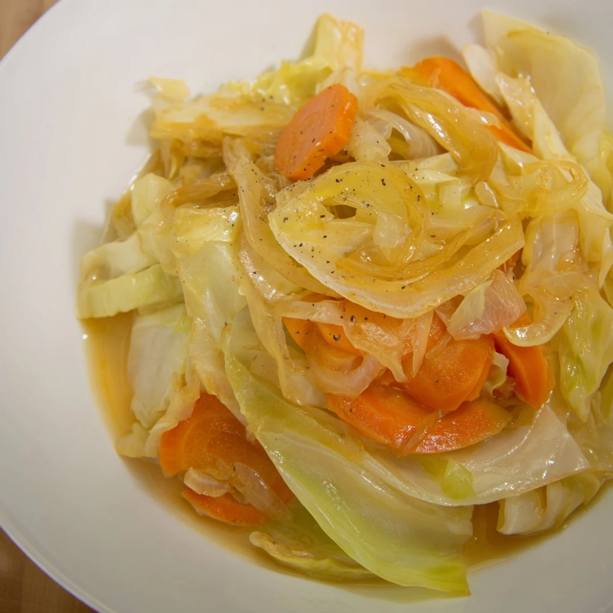 Aromatic Savory Braised Cabbage Recipe served hot alongside roasted sausages or grains
