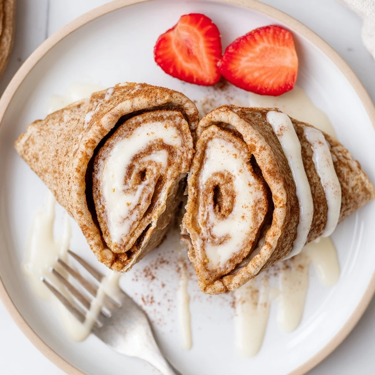 Folded Cinnamon Roll Protein Crepes Recipe filled with creamy cinnamon swirl, warm