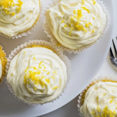 Moist Limoncello Cupcakes topped with fluffy frosting and fresh lemon zest for summer gatherings.
