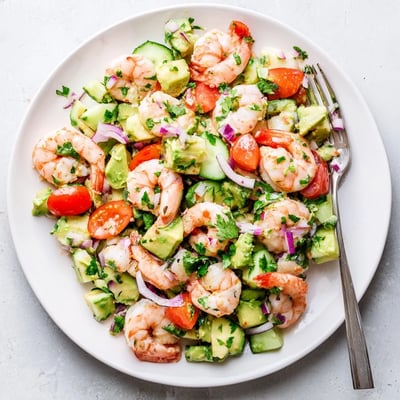 This Healthy Shrimp Avocado Salad showcases vibrant colors, creamy texture, and a zesty lime dressing on a light lunch spread.