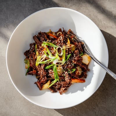 Overhead view of Korean Style Pot Roast served with daikon, carrots, and onions, ready to be paired with steamed rice for dinner.