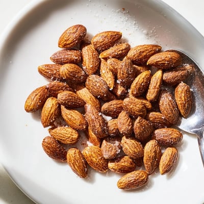 Crunchy roasted almonds seasoned with sea salt in a rustic ceramic bowl